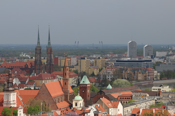 Fototapeta na wymiar View from the tower of the church of St. Elizabeth to the Cathedral, Ostrów Tumski, old town, churches, Odra River, the Olympic Stadium, dormitories, blocks of flats. Wrocław, Breslau, Wroclaw, Poland