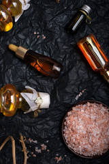set of nature precious oils and  cosmetics on black background .