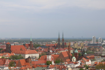 Fototapeta na wymiar Warm, spring day in Wroclaw. View from the tower of the church of Saint Elizabeth to the Cathedral, Ostrów Tumski, old town, churches, Odra River, blocks of flats, the Olympic Stadium, dormitories