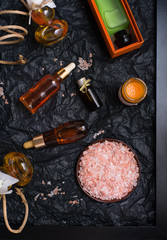 set of nature precious oils and  cosmetics on black background .