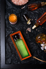set of nature precious oils and  cosmetics on black background .