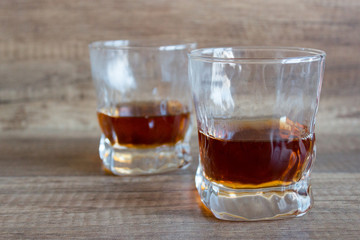 Glass of whiskey, bourbon on a wooden background. Scotch. Alcoholic drink