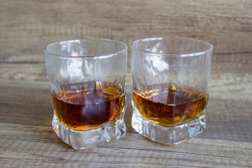 Glass of whiskey, bourbon on a wooden background. Scotch. Alcoholic drink
