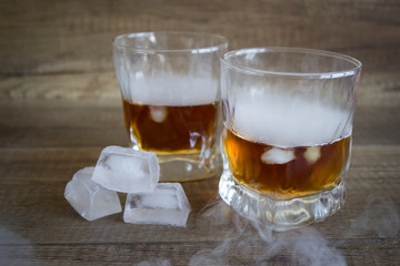 Two glasses of whiskey, bourbon in a glass. Alcoholic drink. Whiskey with ice