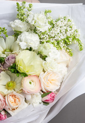 Very delicate handmade bouquet in the hands of the girl florist, a great gift, fresh and neat, interesting gradient, part of the bouquet