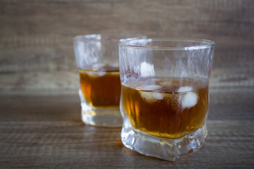 Glass of whiskey, bourbon on a wooden background. Scotch. Alcoholic drink
