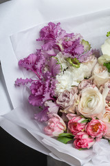 Very delicate handmade bouquet in the hands of the girl florist, a great gift, fresh and neat, interesting gradient