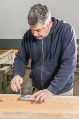 Male carpenter working in his carpentry workshop.