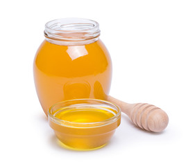 honey dipper and honey in jar on white background