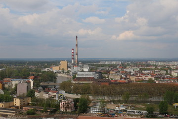 Warm, spring day in Wroclaw. View from the church of St. Elisabeth to the city center, downtown. Visible buildings, tenements, bridge, Odra river, blocks of flats, heat and power station, chimneys.