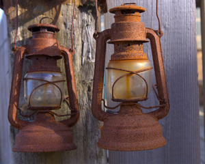 Pair of rusty old lanterns hanging up