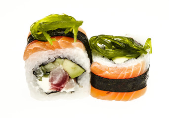 Japanese roll wrapped in a thin slice of salmon and garnished with seaweed. Isolated on a white background