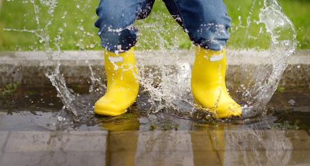 Toddler jumping in pool of water at the summer or autumn day