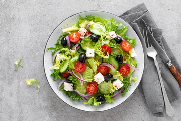 Poster Vegetable salad with fresh cucumber, tomato, olive, onion, lettuce and feta cheese. Healthy food. Top view © Sea Wave
