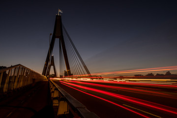 traffic in motion across a bridge at dawn