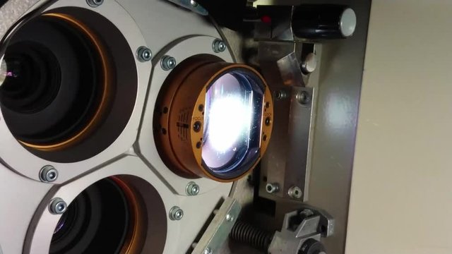 Close up of a 35mm cinema projector in a movie theater