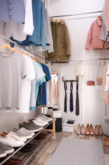 Modern dressing room with different stylish clothes and accessories