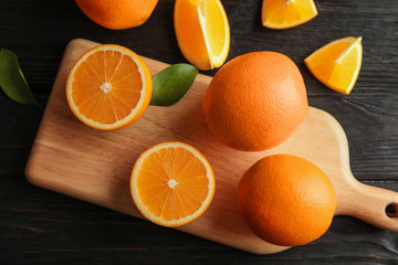 Fresh juicy oranges on wooden table, top view