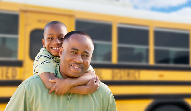 African American Man and Child Piggyback Near School Bus
