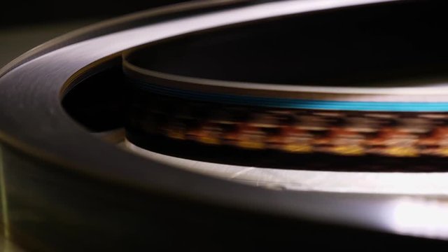 Close up of a moving 35mm film stripe in a movie theater