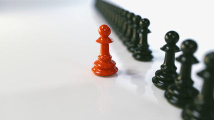 Leadership concept, red pawn of chess, standing out from the crowd of blacks