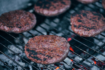 selective focus of grilled fresh burger cutlets on bbq grid
