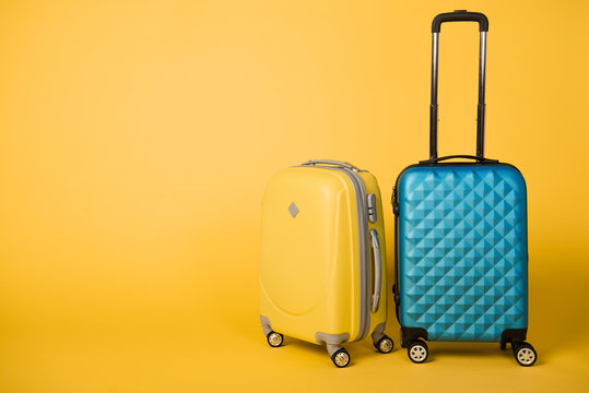 Bright Yellow And Blue Travel Bags On Yellow Background