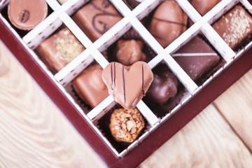 Assorted luxury chocolate candies in a gift box. Chocolate heart