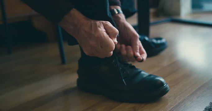 Senior man tying his shoestrings