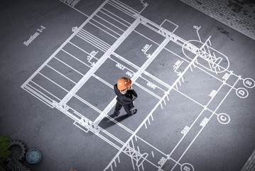 Man engineer thinking over his plan. Mixed media