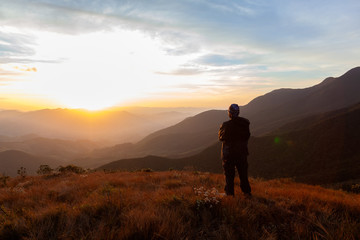 Unrecognized people enjoying the mountain landscape view from a mountain