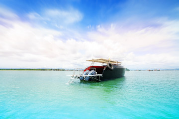 Cool sea with island background on horizon tropical sandy beach; relaxing outdoors vacation with heavenly mind view at a resort deck touching sunshine, sky surf summer clouds and light blue wave ocean