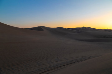 Obraz na płótnie Canvas Desert during sunset at Huacachina Oasis in Ica, Peru.