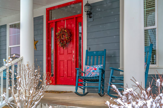Winter view of home with red door and front porch