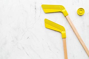 Ice hockey stick and puck on white stone background top view space for text