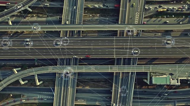 Aerial view from above of traffic on the elevated expressway with futuristic autonomous, driverless cars using artificial intelligence computer network and satellite gps for navigation