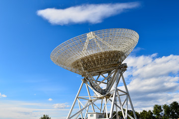 Array of satellite dishes or radio antennas against sky. Space o