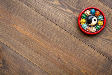 Buddhist symbol. Yin Yang symbol on dark wooden background top view copy space