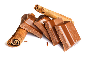 Tasty milk chocolate closeup with cinnamon sticks isolated on white background