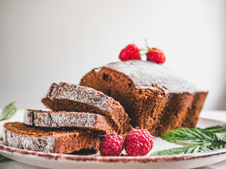 Chocolate cake, fresh berries, vintage plate on a white background. Concept of delicious food
