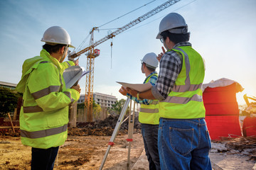 Construction engineers discussion with architects at construction site or building site of highrise...