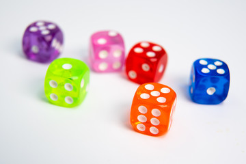 Dice of different colors isolated on a white background.