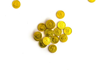 Bunch of chocolate gold coins on white background