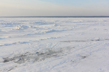 Fototapeta na wymiar Ice road, river crossing on the Ob reservoir, Novosibirsk region, Western Siberia, Russia