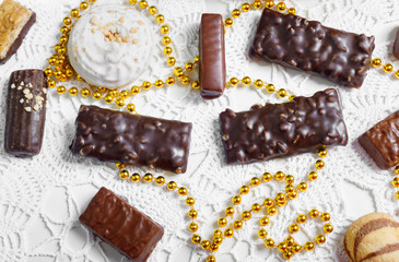 Set of delicious cookies, chocolates, biscuits on  table