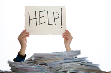 Person under a pile of papers with a hand holding a sign of help. Accounting.