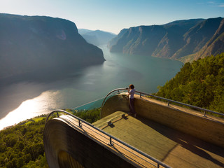 Tourist enjoying fjord view on Stegastein viewpoint Norway