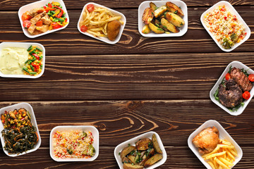 Plastic containers with delicious food on wooden table. Delivery service