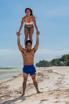 Filipino couple at the beach and yoga poses Stock Photo
