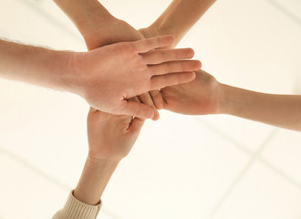 Fototapeta premium People putting hands together as symbol of unity